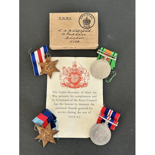 50 - A collection of WW2 era one mans medals, service and release book, a small amount of insignia etc an... 