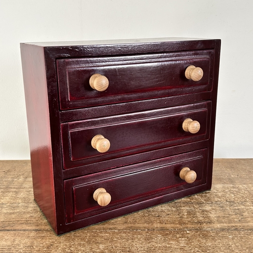 67 - A miniature wooden three drawer jewellery/collectors chest, mahogany stained, approx. 9 1/4