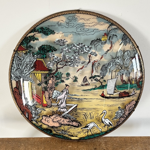 69 - A vintage Oriental reverse decorated wall hanging on domed glass with figures and boats scene, appro... 