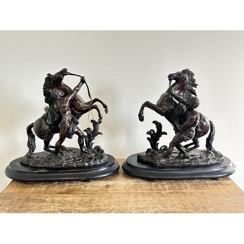 97 - A pair of 19th Century bronze Marley horse and attendant figures, both marked 'Coustou' to base and ... 