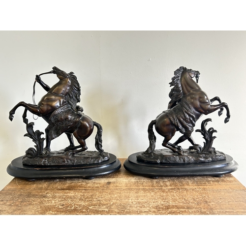 97 - A pair of 19th Century bronze Marley horse and attendant figures, both marked 'Coustou' to base and ... 