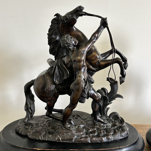 97 - A pair of 19th Century bronze Marley horse and attendant figures, both marked 'Coustou' to base and ... 