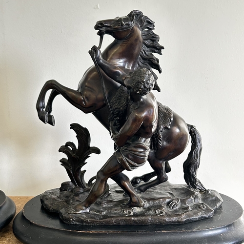 97 - A pair of 19th Century bronze Marley horse and attendant figures, both marked 'Coustou' to base and ... 