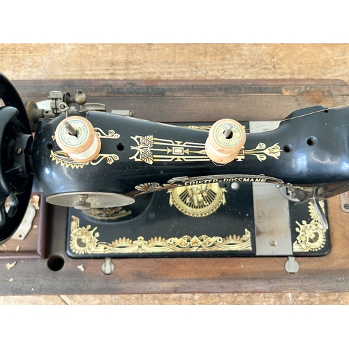 410 - An antique wood cased Frister & Rossmann manual sewing machine with gilded Egyptian decoration (box ... 