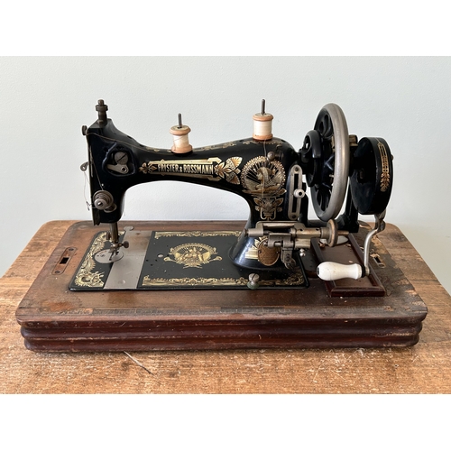 478 - An antique wood cased Frister & Rossmann manual sewing machine with gilded Egyptian decoration (box ... 