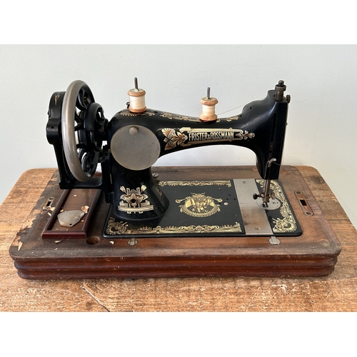 478 - An antique wood cased Frister & Rossmann manual sewing machine with gilded Egyptian decoration (box ... 