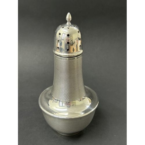 185 - A hallmarked silver sugar caster, Birmingham 1937, this contains a Bakelite lined interior in the ba... 