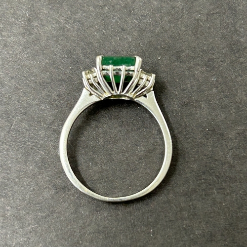 198 - A 750 (18ct) white diamond and green stone set ring, approx. size O, weight approx. 3.7g