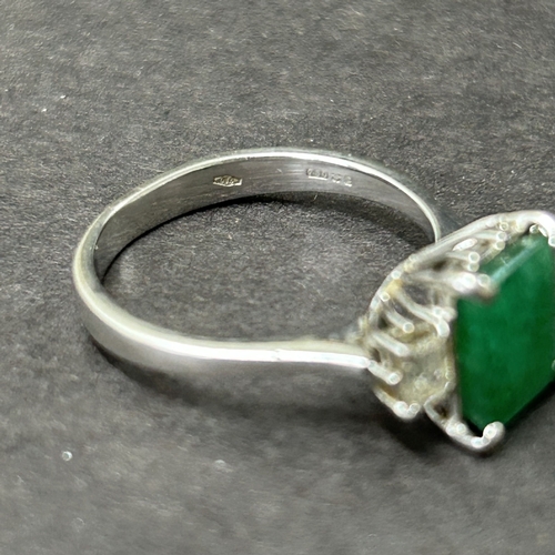 198 - A 750 (18ct) white diamond and green stone set ring, approx. size O, weight approx. 3.7g
