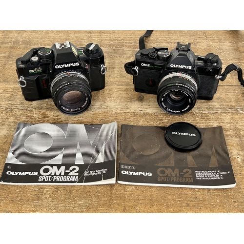 223 - Two vintage 35mm film cameras to include an Olympus OM40 and an Olympus OM2 (both untested and in us... 
