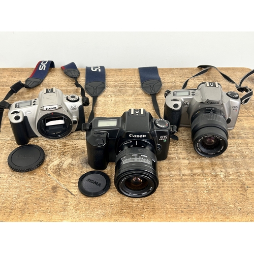 230 - Three Canon SLR film cameras to include an EOS 3000, a EOS 300 and a EOS 1000F (one with body only, ... 