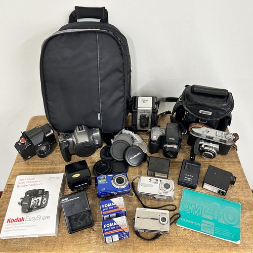 233 - A mixed lot of digital film cameras etc to include a Canon EOS 3000V, Praktica, Kodak etc together w... 