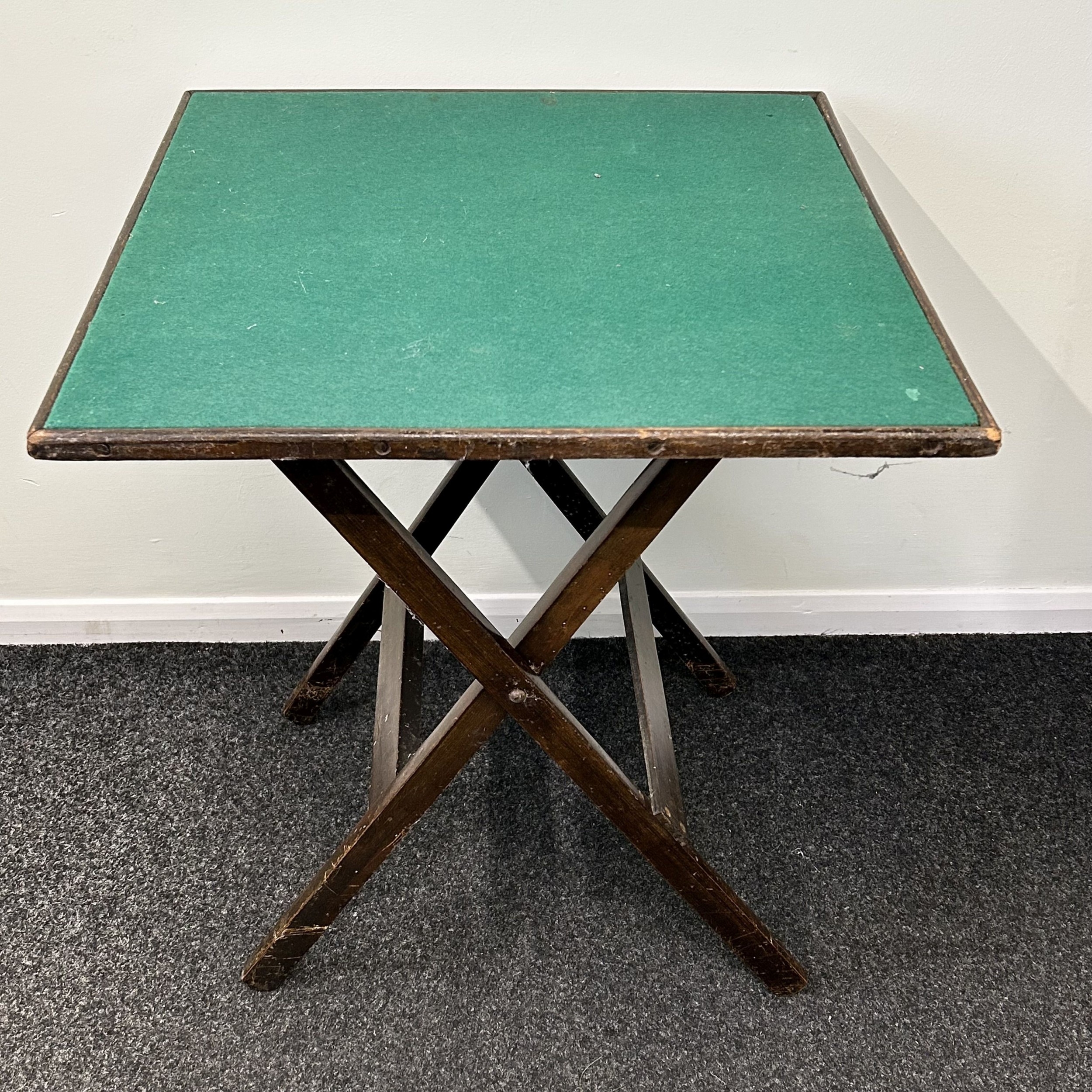 A vintage fold-up card table with green baize, 36