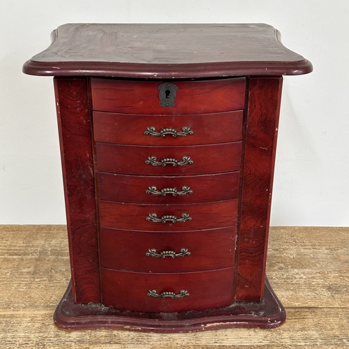 64 - A vintage Oriental style multi drawer jewellery chest with side doors, lift lid and secret drawer lo... 