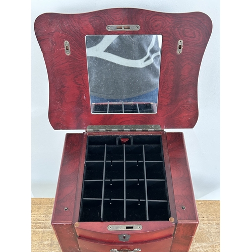 64 - A vintage Oriental style multi drawer jewellery chest with side doors, lift lid and secret drawer lo... 