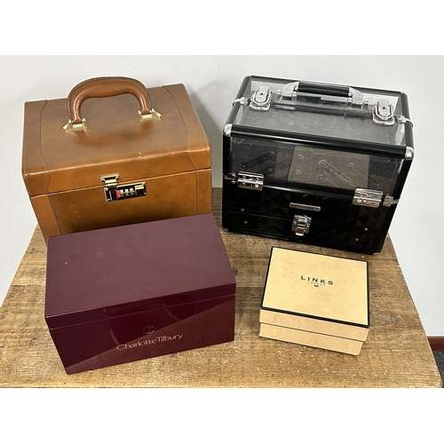 65 - A leather covered jewellery box, a black and clear plastic example, an empty Links box and an empty ... 