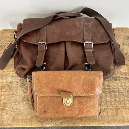 66 - A vintage leather suitcase with working catches and monogrammed top together with a leather satchel,... 