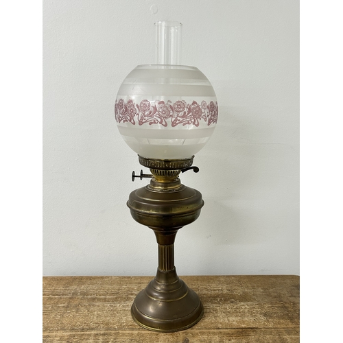 74 - A vintage brass base oil lamp with glass shade, approx. 22