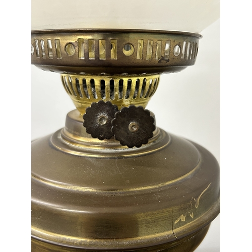 74 - A vintage brass base oil lamp with glass shade, approx. 22