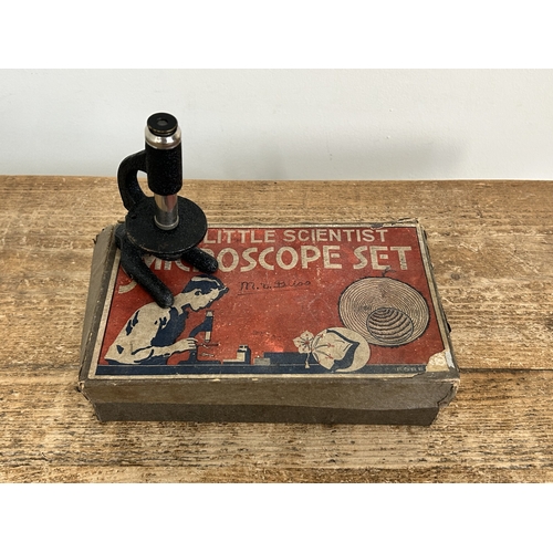 80 - A vintage boxed 'The Little Scientist' microscope (contents disturbed and box with age and wear)