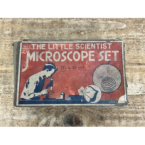 80 - A vintage boxed 'The Little Scientist' microscope (contents disturbed and box with age and wear)