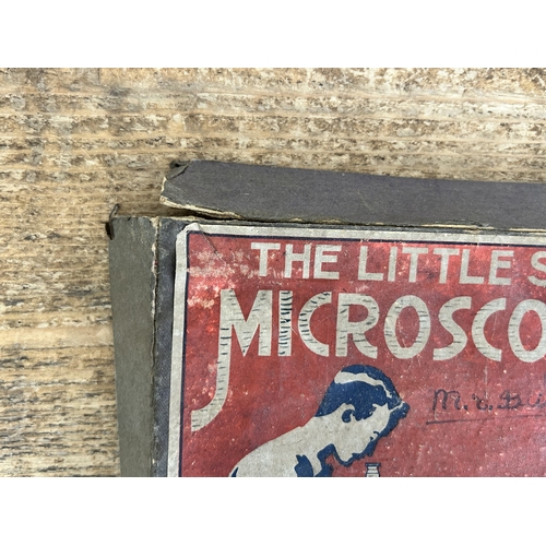 80 - A vintage boxed 'The Little Scientist' microscope (contents disturbed and box with age and wear)