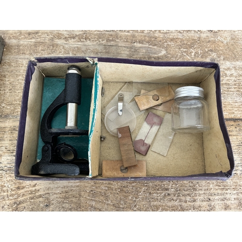 80 - A vintage boxed 'The Little Scientist' microscope (contents disturbed and box with age and wear)