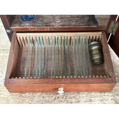 81 - A boxed Victorian Watson & Sons High Holborn London brass microscope, drawer in case containing clea... 