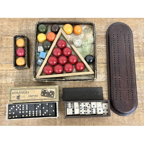 83 - Boxed vintage snooker balls (not full sized) together with two sets of dominoes and a crib board