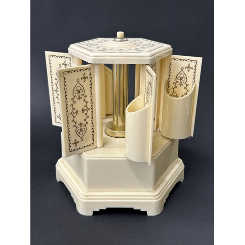 91 - A vintage Selcol musical cigarette dispenser, also known as a lipstick carousel, approx. 7 3/4