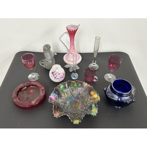 95 - Mixed vintage coloured glassware including an opaline jug, cranberry, Carnival, a Wedgwood otter etc... 