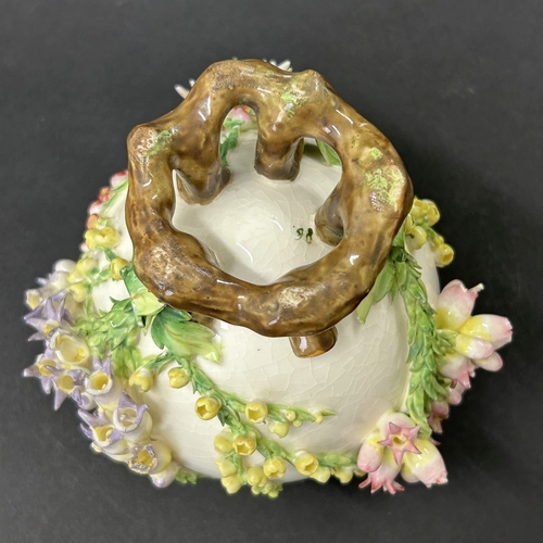 99 - An unusual vintage flower encrusted small vase, approx. 5