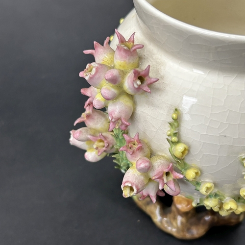 99 - An unusual vintage flower encrusted small vase, approx. 5