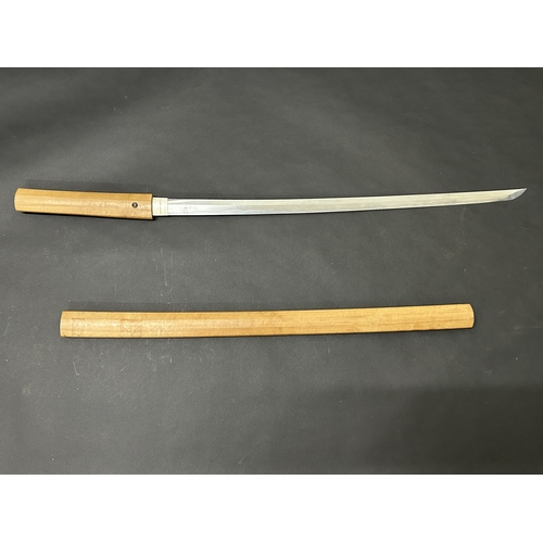 200 - An antique Japanese Katana in a natural wood scabbard, no marks to tang, polished blade with hamon m... 