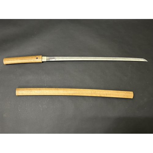 200 - An antique Japanese Katana in a natural wood scabbard, no marks to tang, polished blade with hamon m... 