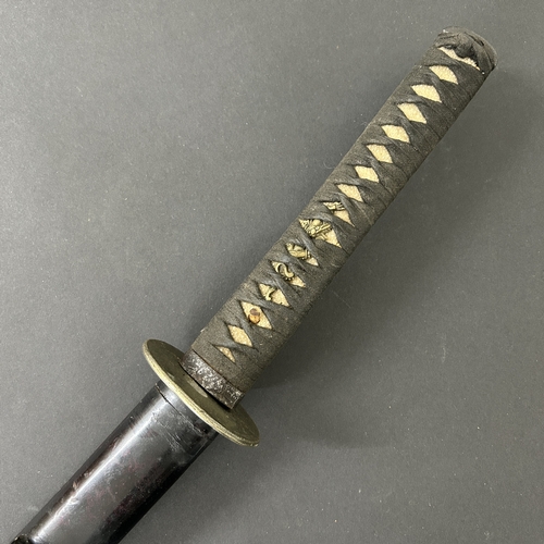 201 - An antique Wakizashi Japanese sword in a lacquered wooden scabbard with re-attached loop, polished b... 