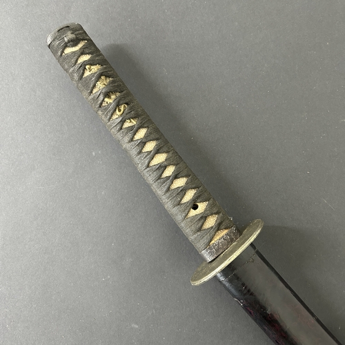 201 - An antique Wakizashi Japanese sword in a lacquered wooden scabbard with re-attached loop, polished b... 