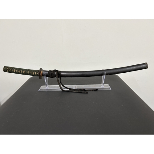 203 - An antique Wakizashi Japanese sword in scabbard, polished with traces of hamon marks, decorated Tsub... 