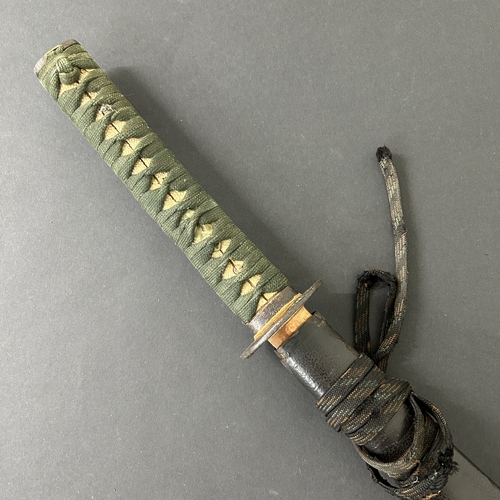 203 - An antique Wakizashi Japanese sword in scabbard, polished with traces of hamon marks, decorated Tsub... 