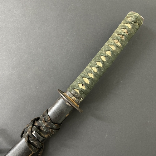 203 - An antique Wakizashi Japanese sword in scabbard, polished with traces of hamon marks, decorated Tsub... 