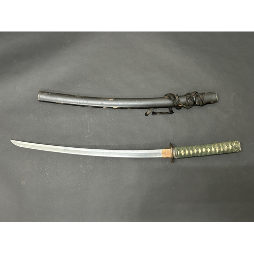203 - An antique Wakizashi Japanese sword in scabbard, polished with traces of hamon marks, decorated Tsub... 