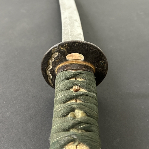 203 - An antique Wakizashi Japanese sword in scabbard, polished with traces of hamon marks, decorated Tsub... 