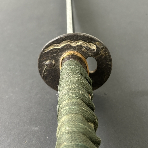 203 - An antique Wakizashi Japanese sword in scabbard, polished with traces of hamon marks, decorated Tsub... 