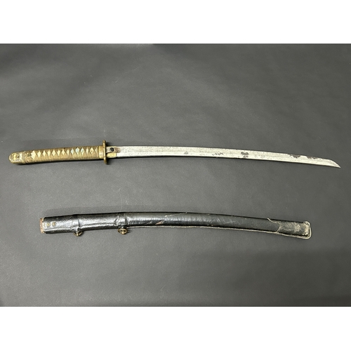 206 - A Japanese Shin-Gunto sword in leather covered scabbard, polished blade, Tsuka with Menukis, signed ... 