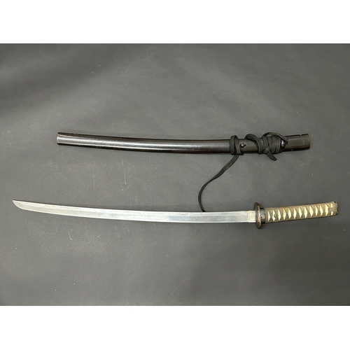 207 - A Japanese Katana in a wooden scabbard, the blade has been sharpened and is polished, plain Tsuba, b... 