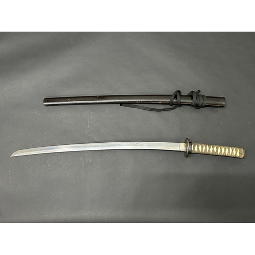 207 - A Japanese Katana in a wooden scabbard, the blade has been sharpened and is polished, plain Tsuba, b... 