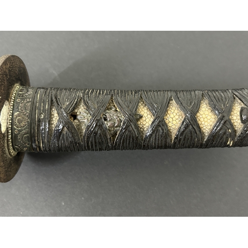 208 - An antique Japanese Wakizashi in non-matching leather covered wooden scabbard, polished blade, a Tsu... 