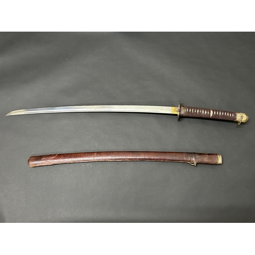 209 - A Japanese emergency issue WW2 military Shin-Gunto sword in a leather covered wooden scabbard, polis... 
