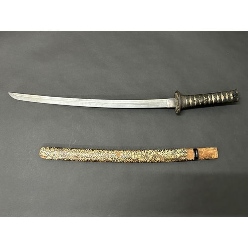 213 - An antique Wakizashi Japanese sword in a wooden scabbard with ray skin, polished blade, signed tang,... 