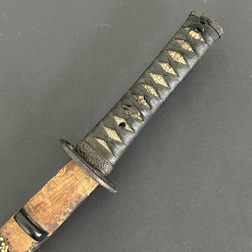 213 - An antique Wakizashi Japanese sword in a wooden scabbard with ray skin, polished blade, signed tang,... 
